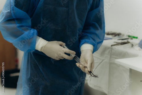 Surgeon hands preparing medical instruments for operation