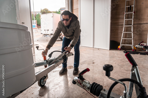 Vászonkép Man attaching a trailer hitch to a travel vehicle, focusing on the connection me