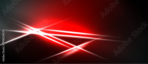 Abstract red light streaks intersect. Bright starburst effect dominates dark background. Dramatic visual impact.