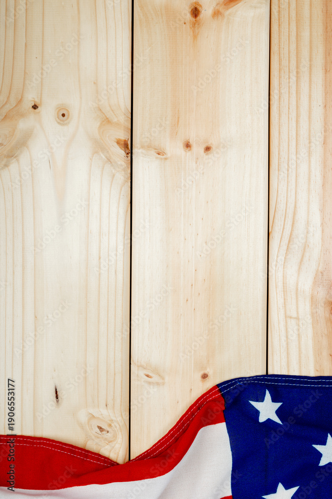 Obraz premium Directly above view of usa flag with stars and stripes on wooden table with copy space