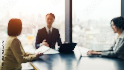 Blurred image of a group of business people meeting in an office