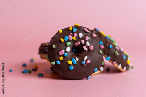 Fotografía Colorful Donuts With Sprinkles On A Pink Background Delightfully