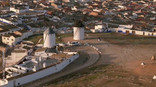 Aerial view of the iconic windmills standing tall amidst the white-washed buildings, creating a stunning contrast of colors, Campo de Criptana, Castile-La Mancha, Spain.