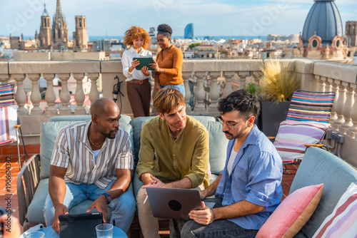 Photography Diverse colleagues having a casual outdoor rooftop meeting