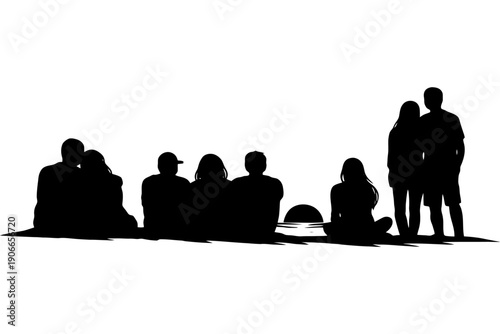 Silhouette of diverse group watching sunset on beach.