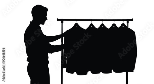 Man selecting clothes from a rack a striking black silhouette