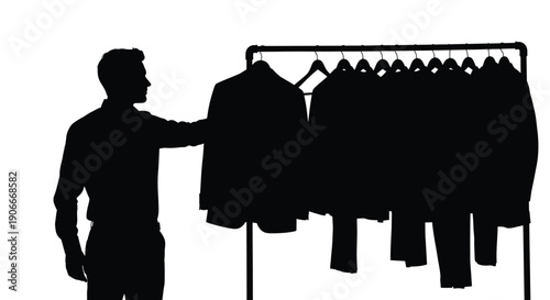 Man selecting clothing from a rack a striking black silhouette