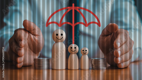 Wooden figures representing family protected by red umbrella and hands with stacks of coins.