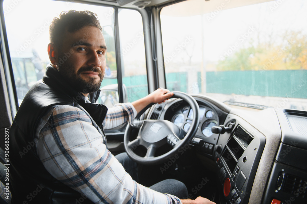 Naklejka premium Truck driver sitting in cabin, transporting goods by road