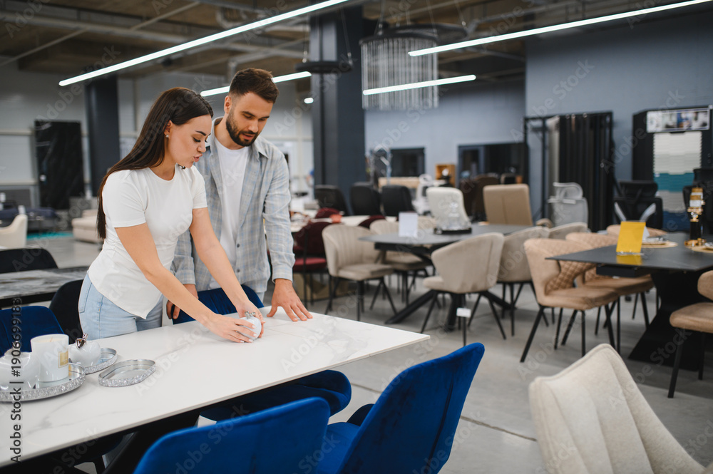 Naklejka premium Couple shopping in furniture store, choosing home decor