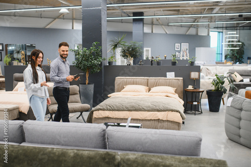Valokuva Sales consultant assisting female customer in furniture store