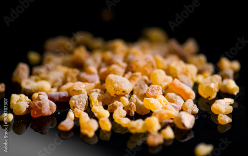 Quadro su tela Frankincense olibanum resin, Boswellia sacra Isolated on black background
