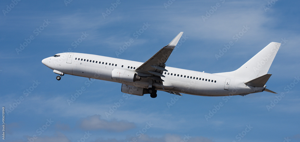 Obraz premium Airplane take off on the blue sky, with white clouds. Aircraft flying on sky background. White passenger jet plane in the blue sky. Low angle view of Airplane flying under blue sky, with white clouds