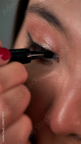 Woman Applying Eyeliner, Brow Gel, and Mascara Makeup