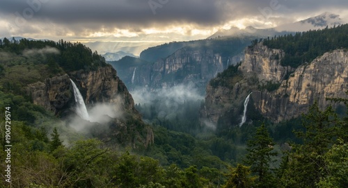 Lush forest valley with breathtaking huge waterfalls set against distant mountain ranges