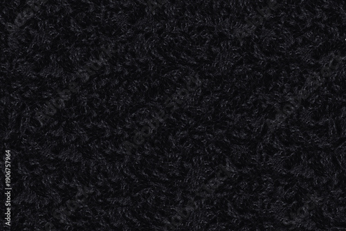 Dark black curly sheep wool texture background, close-up of natural fluffy lamb fur textile material