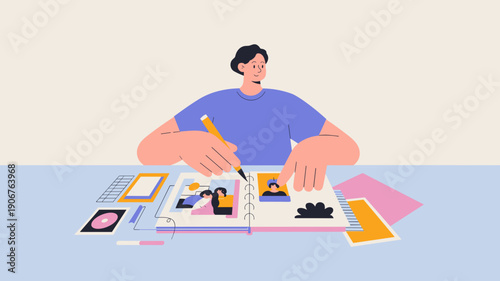 man arranging photos and decorations in a scrapbook on a desk, scrapbooking and creative hobby concept