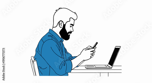 Bearded man in blue shirt using smartphone at desk with laptop