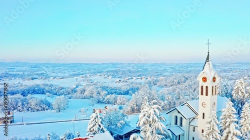 Aerial Winter Village with Snow-Covered Church and Countryside Landscape