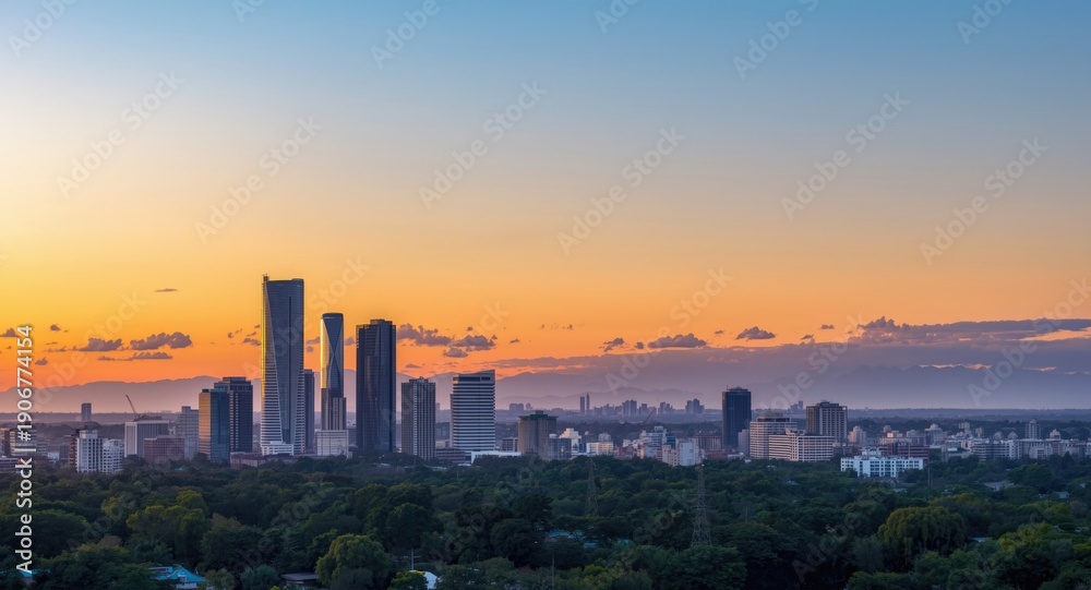 Fototapeta premium Colorful sunset bathes urban horizon alongside far mountains illustrating the arrival of a new season