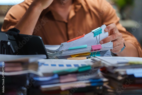 Accountant Organizing Paperwork for Tax Preparation before the Deadline, managing every Document and Management task for Business Finance and Professional Accounting.