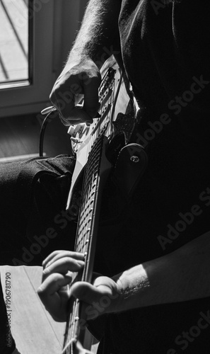 Electric Guitar Player Hands Close-Up in Dramatic Black and White