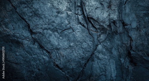 Closeup of textured bedrock wall with wood grain patterns and dark icy tones