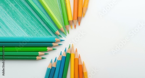 Colorful pencils arranged on a clean blank surface ideal for text copy space
