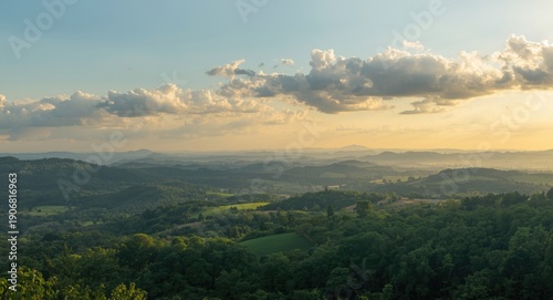 Bright sky with clouds over a green summer hilly outdoor landscape