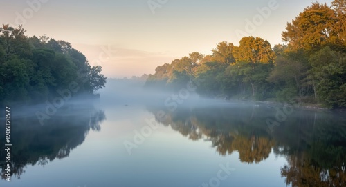 Calm misty river scene at dawn with peaceful fog and soft light on trees