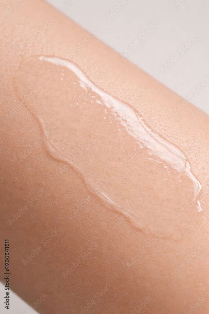 Fototapeta premium Liquid Gel Serum Texture on Human Skin, Skincare Product Macro