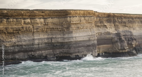 Cliffside sediment layers limestone sandstone siltstone and mudstone along coastal region