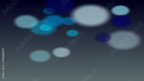 Abstract blue bokeh lights floating in the dark.