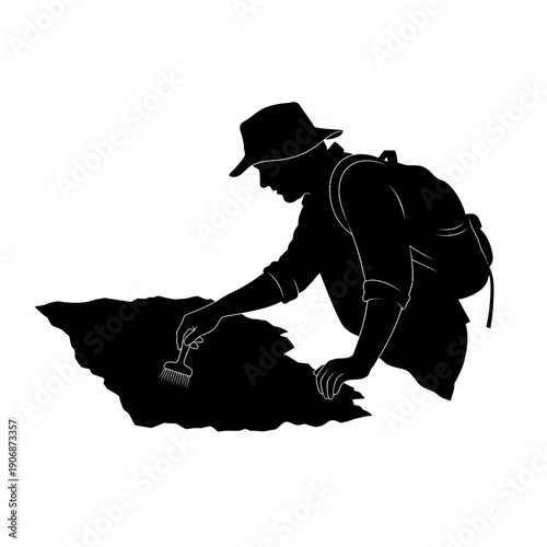 Silhouette of an Archaeologist Examining a Map with a Brush.