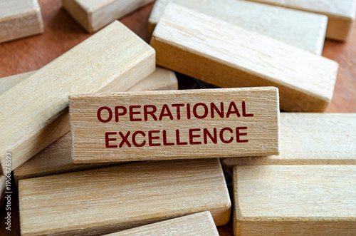 Fotografie OPERATIONAL EXCELLENCE text on wooden blocks with ladder on notebook symbolizing structured improvement and high performance culture