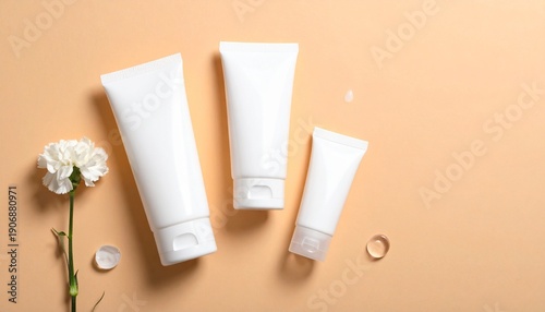 Wallpaper Mural Hand holding yellow-orange cosmetic tube on bright orange background, halved orange with green leaf in front, clean vibrant composition emphasizing freshness and skincare. Torontodigital.ca