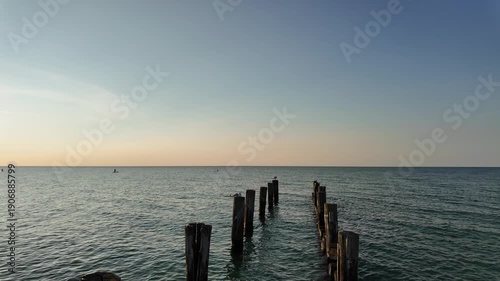 Wooden groynes and waves on the Baltic Sea at sunset