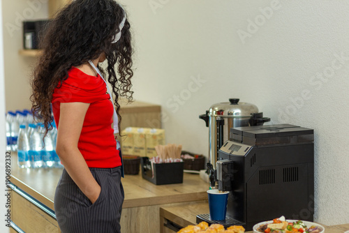 Wallpaper Mural Woman in red top using a coffee machine at an office break area. Torontodigital.ca