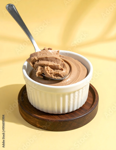 Chocolate Mousse in White Ramekin with Spoon on Yellow
