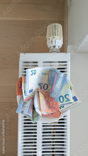 Wallpaper Mural Euro notes on radiator portray hardship across Baltic region, hardship squeezes wages, hardship pushes families to ration warmth, inequality, crisis news, support programs Torontodigital.ca