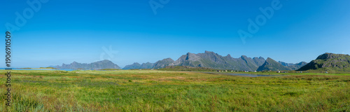 Panel kuchenny z motywem Landscape near Fredvang with the Norwegian Sea, an impressive mountain backdrop, and the striking peak of Volandstind. Lofoten in Norway.