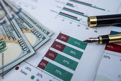 Close up of Total Sales Report Graph with US Dollar Banknotes and Luxury Fountain Pen