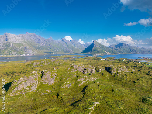 Aerial view of the North Atlantic coastal landscape near Fredvang, in background the distinctive peak of Volandstind, Lofoten Norway
