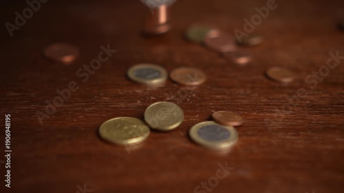Euro coins falling on table in slow motion