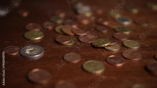 Euro coins bouncing on table in slow motion