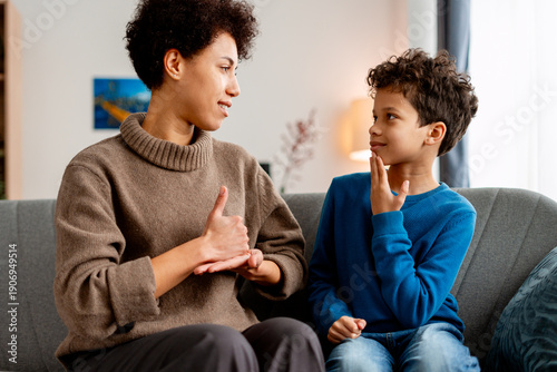 Canvastavla Mother and son communicating with sign language at home, fostering inclusion