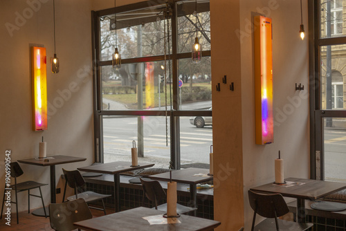 Foto Sunlit cafe interior with colorful panels and large windows