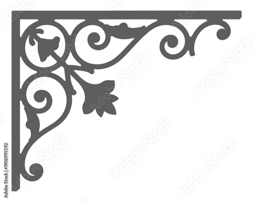 Ornate cast iron bracket with floral scrollwork design is isolated on white.