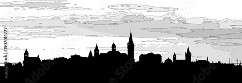 Silhouette of a European city skyline with varied architecture against a cloudy sky