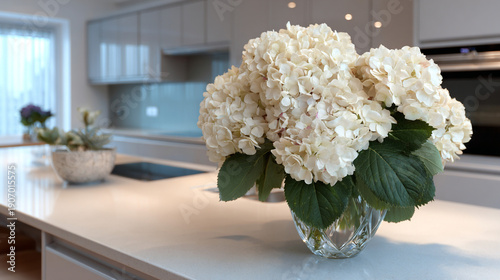 An open plan kitchen with new appliances with bouquet.
